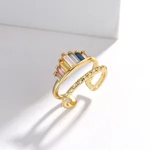 Detailed macro of 18K gold ring with colorful zircon baguettes and floral engraving