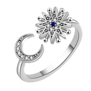 Star and moon open ring with blue stone and cubic zirconia in silver-colored metal
