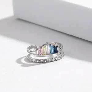 Detail of double-layer silver ring with colorful baguette-cut stones and pavé set zircons