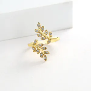 Macro detail of adjustable olive leaf branch ring with sparkling zircon stones