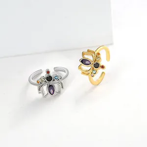 Macro detail of gold and silver lotus rings featuring colorful zircon stones and adjustable band