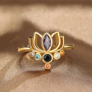 Lotus flower ring with multicolor gemstones and adjustable gold band on silk background