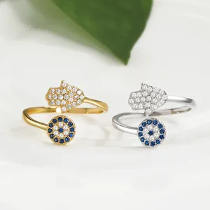 Adjustable gold and silver Hamsa Evil Eye rings with blue sapphire and zircon pavé