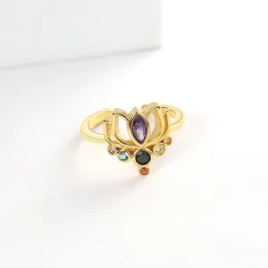 Macro view of gold-plated lotus ring with colorful zircon and purple marquise gemstone