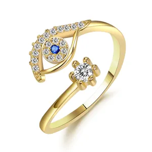 Evil eye open ring in gold finish with blue sapphire and sparkling white diamonds