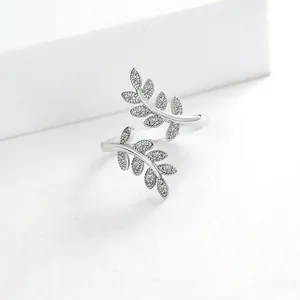 Detailed view of silver olive branch ring featuring white zircon leaves and adjustable open band