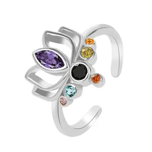 Adjustable lotus ring in gold finish with vibrant multi-color gemstones and a purple center