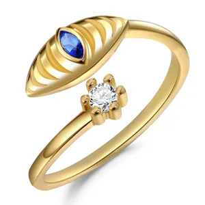 Adjustable gold ring with blue marquise gem and round white stone in 6-prong setting