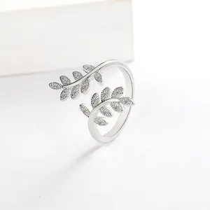 Detail of silver leaf open ring featuring micro-paved white zircons on olive branch
