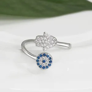 Macro detail of Evil Eye and Hand of Fatima ring with blue and clear zircon stones