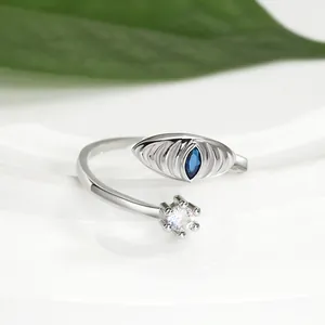 Detail of blue marquise gemstone and six-prong cubic zirconia on open silver ring