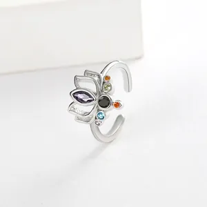 Detailed close-up of a silver lotus ring featuring colorful multi-gemstone inlay