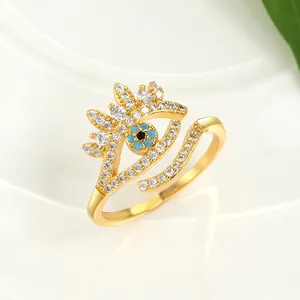 Macro shot of gold evil eye open ring featuring blue crystals and sparkling white zircons