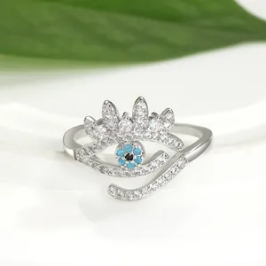 Detailed close-up of a silver-toned evil eye open ring featuring blue and white zircons