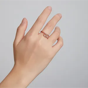 Close-up of rose gold snake ring with zircon eyes and detailed scale texture on hand