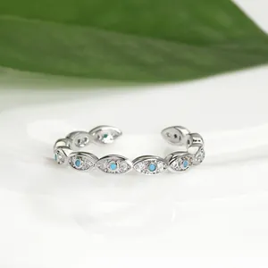 Detailed view of evil eye ring with blue zircons and adjustable silver band