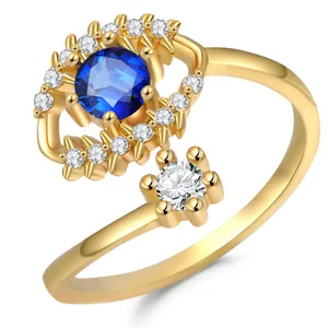 Gold plated olive branch ring featuring a blue evil eye design with crystal accents