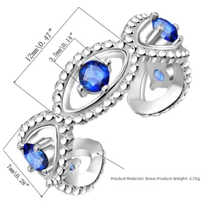 Macro view of silver evil eye ring with blue gemstones and detailed brass craftsmanship