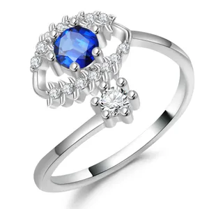 Silver olive branch ring with evil eye blue stone and white diamonds on white base