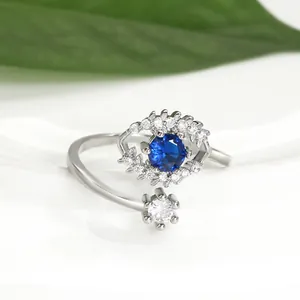 Detailed close-up of Evil Eye silver open ring with blue stone and floral zircon accents