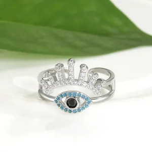 Detailed macro shot of double-layer crown and evil eye open ring with blue stones