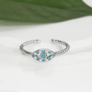 Vista macro de un anillo de ojo turco con piedras azules y diseño de banda trenzada