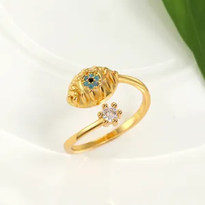 Detailed macro view of gold evil eye open ring with blue stone and star accent