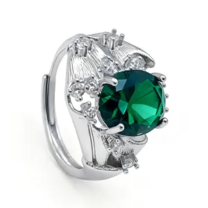 Luxurious silver ring with large green gemstone and floral pavé diamond details
