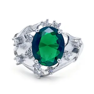 Elegant silver ring with oval green gemstone and white crystal floral cluster setting