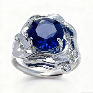 Minimalist sterling silver ring featuring a large round blue gemstone in a claw setting