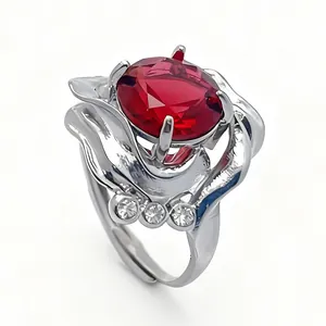 Detail view of flower petal silver ring with red oval gemstone and accent diamonds