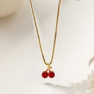 Elegant gold cherry pendant necklace with red crystals and micro-pave cubic zirconia stones