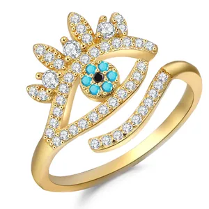 Macro shot of 18K gold plated evil eye ring with blue stones and adjustable band