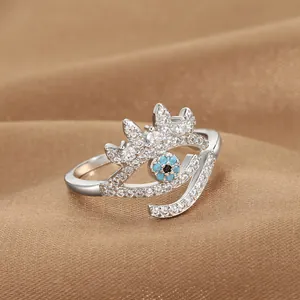 Macro shot of silver evil eye crown ring with blue stone and cubic zirconia inlay