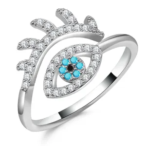 Macro detail of Evil Eye ring with blue crystals and sparkling micro-pave white diamonds