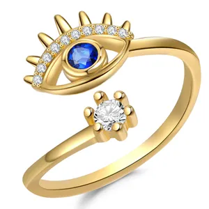 Macro detail of gold-plated evil eye open ring with blue and white zircon stones