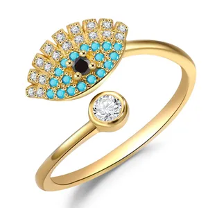 Macro shot of evil eye ring in gold with turquoise stones and adjustable band detail