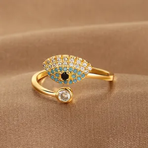 Detail shot of a gold-plated evil eye ring with blue and white pavé cubic zirconia