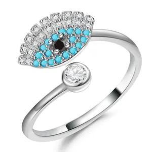 Macro detail of silver adjustable ring featuring a blue evil eye design with zircons