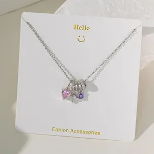 Silver chain necklace featuring pink heart and purple oval zircon pendants on display card