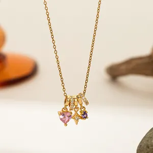Detail of gold necklace with pink heart zircon, star pendant and micro-set crystals