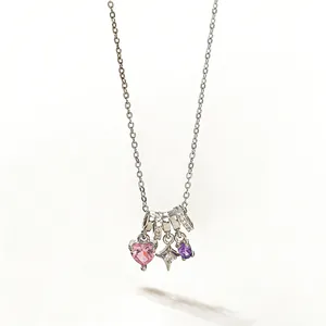 Close-up of heart and star pendants with pink and purple zirconias on silver chain