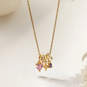 Golden heart necklace with pink heart gem, star charm and purple stones on chain
