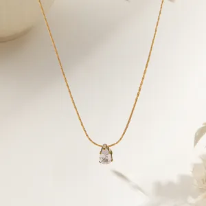 Pear shape drop crystal necklace in 18K gold plated stainless steel on a white background