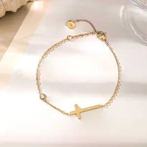 Détail du bracelet croix plaqué or 18 carats orné d'un zircon rond étincelant