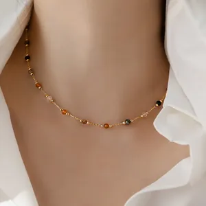 Minimalist 18K gold plated necklace with small natural stone beads on a female model