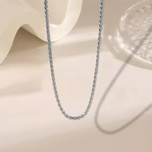 Detailed close-up of a silver-colored rope chain necklace on a minimalist display stand