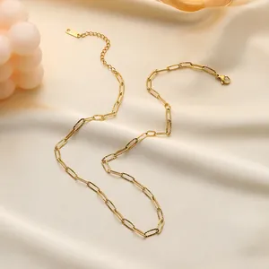 Macro view of gold k18 paperclip chain necklace with textured links and lobster clasp