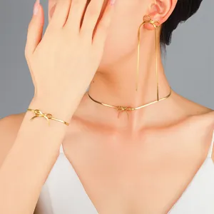 Elegant gold bow jewelry set with snake chain necklace, bracelet and long earring