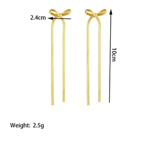 Detailed view of gold tassel bow earrings with 10cm flat snake chain and size markings